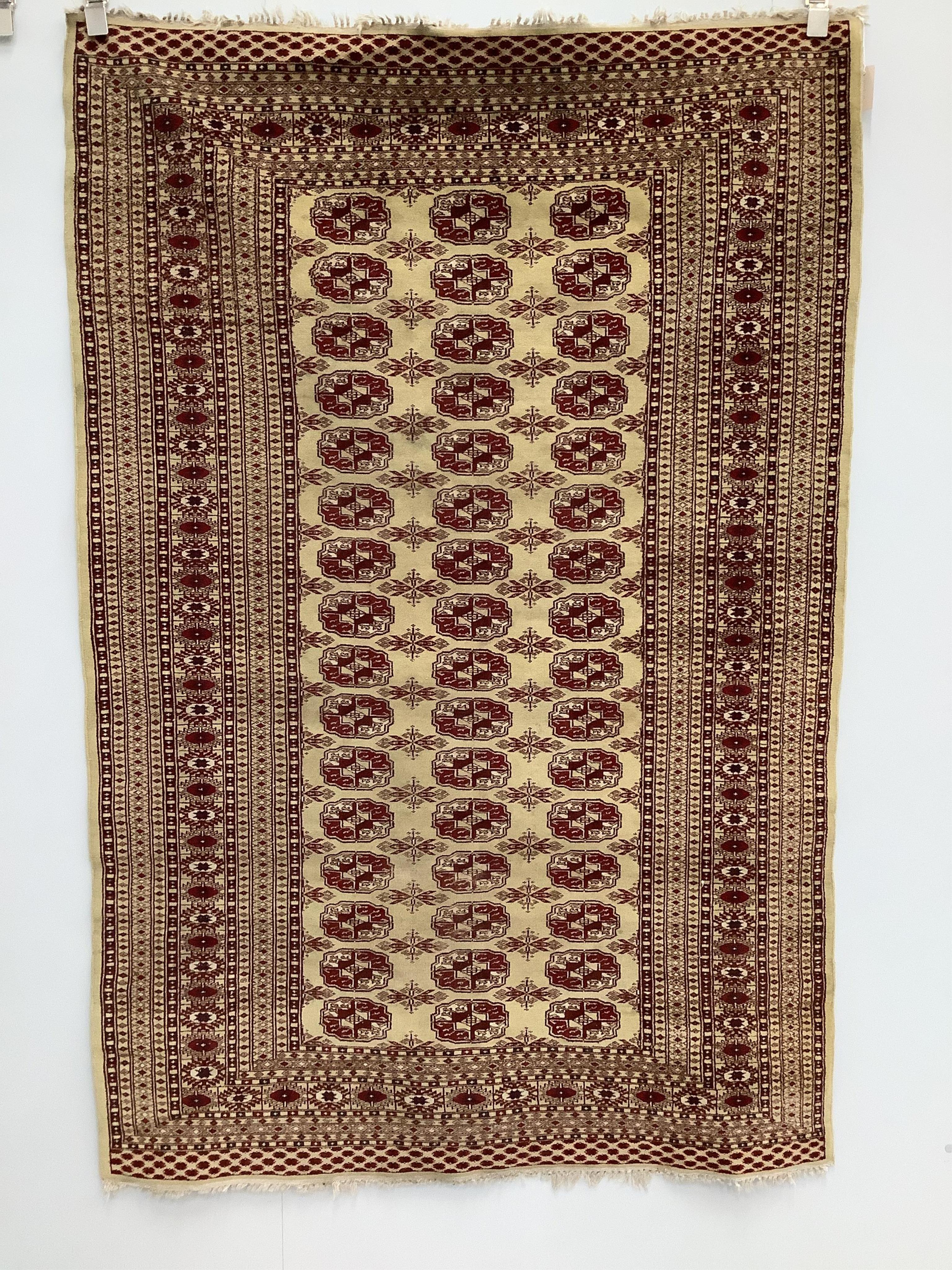 A Bokhara gold ground rug, 190 x 128cm